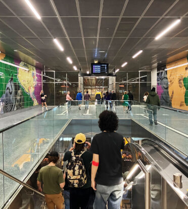 Metro riders descend the escalator at the Wilshire/La Cienega station.