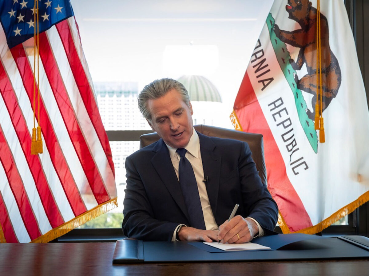 Gov. Newsom signed the legislation in his office surrounded by members of the Capitol Press Corps.